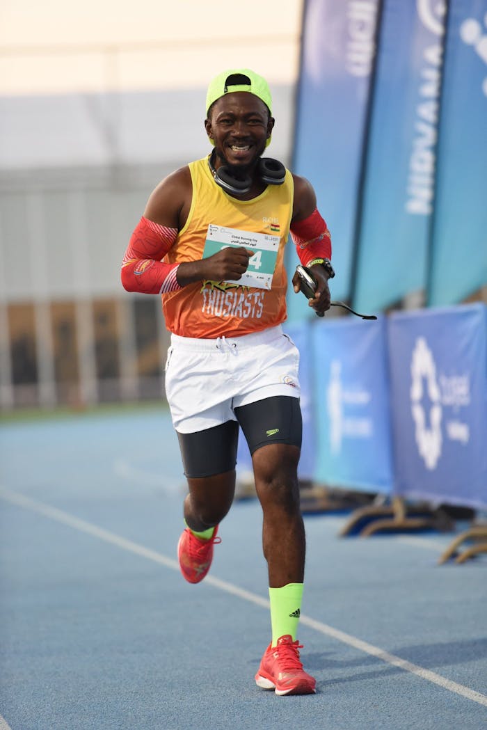 African male athlete participates in an Abu Dhabi marathon, showcasing determination and fitness outdoors.